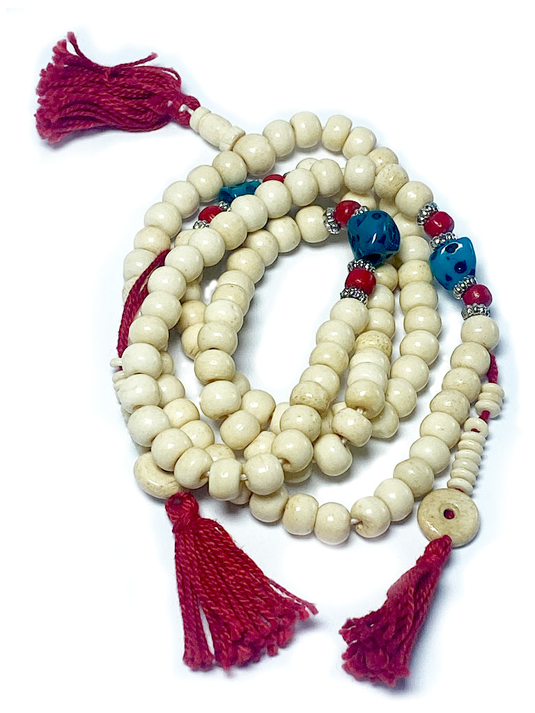 Tibetan bone mala with turquoise Chupsey beads laid flat