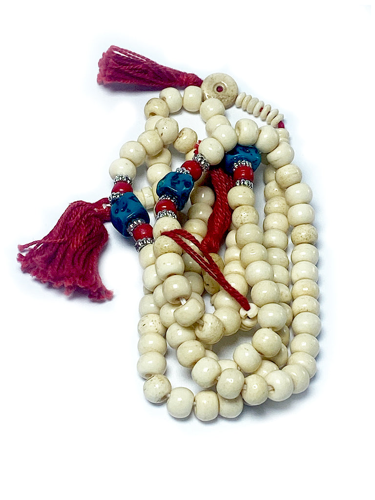 Tibetan bone mala detail showing turquoise and coral beads