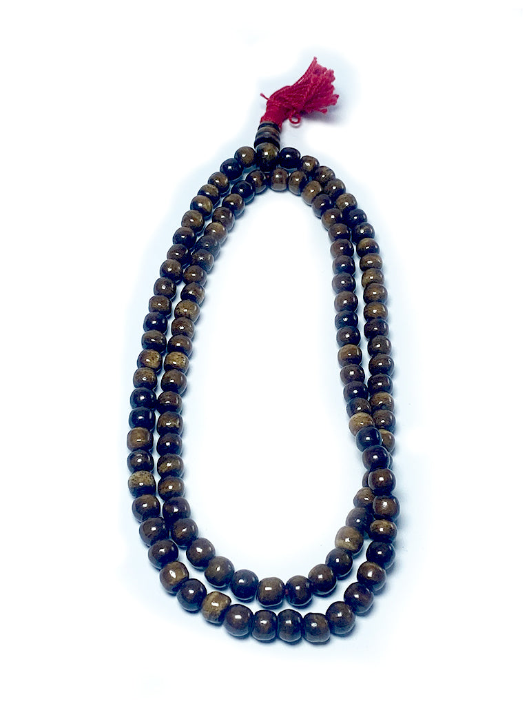 Tibetan coffee bone mala laid out full length
