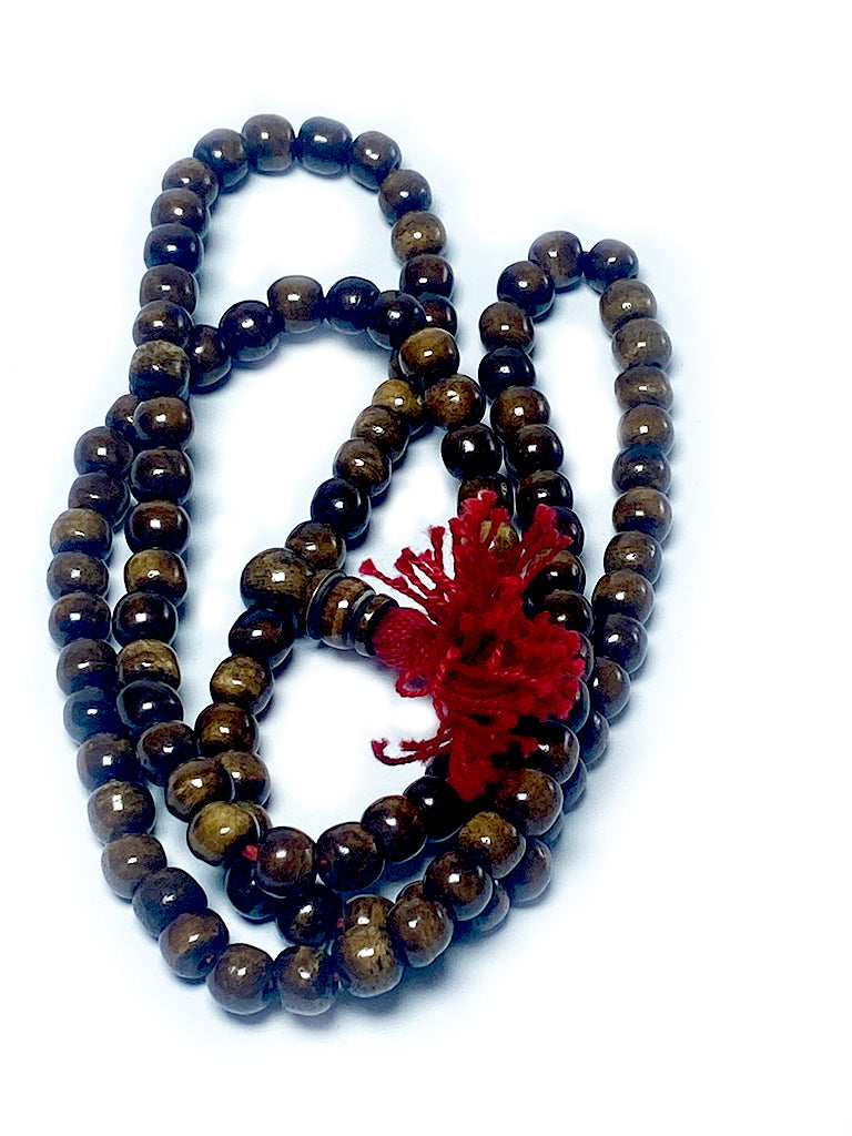Tibetan coffee bone mala with red tassel detail